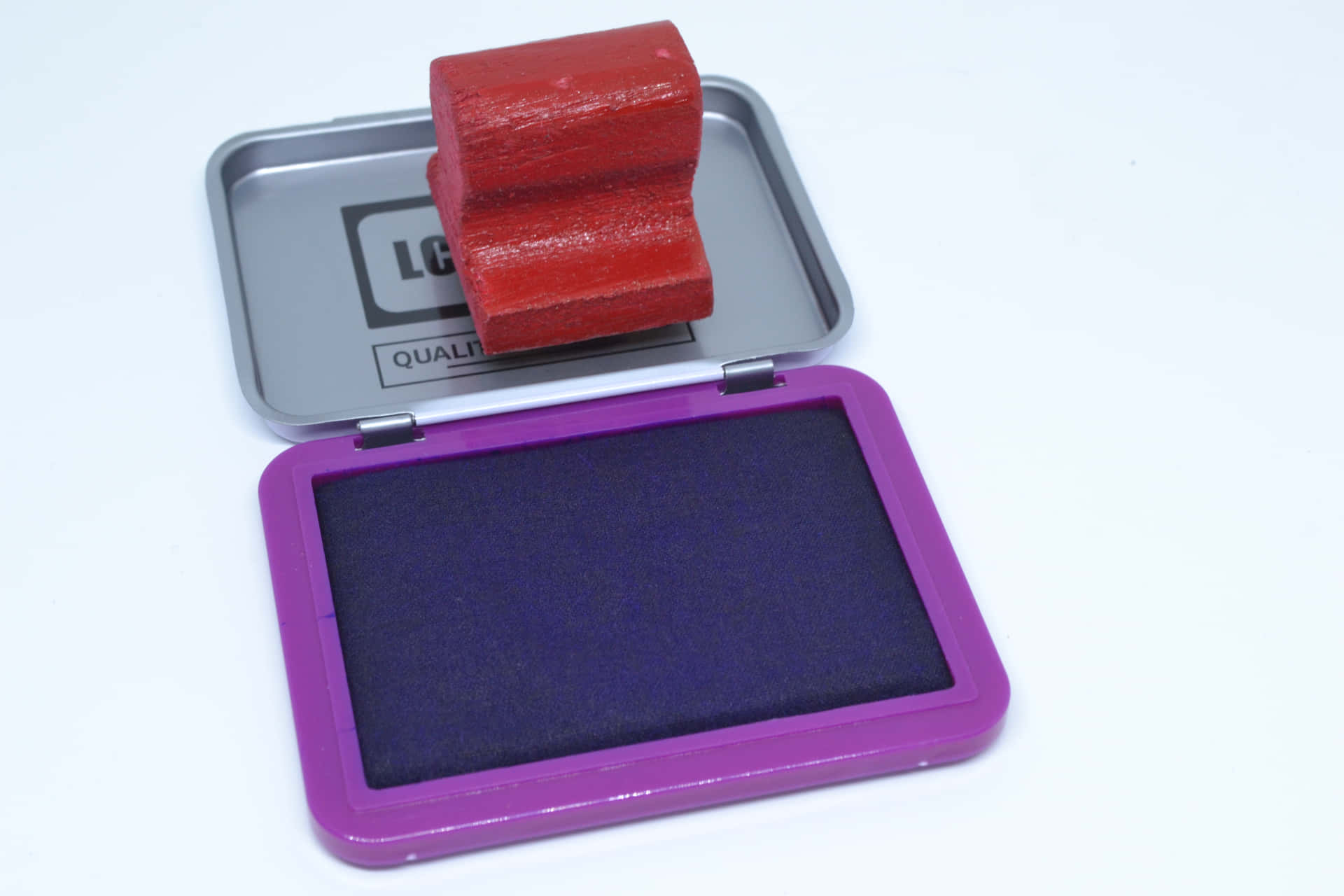 A Purple And Purple Stamp Pad In A Box
