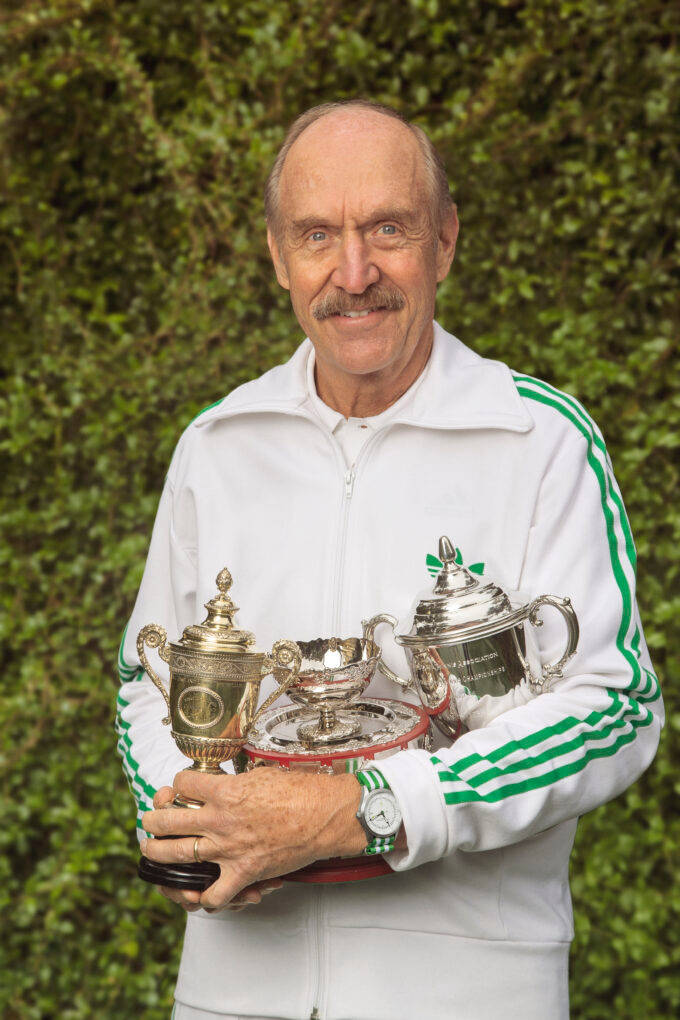 Stan Smith Holding His Trophies Wallpaper