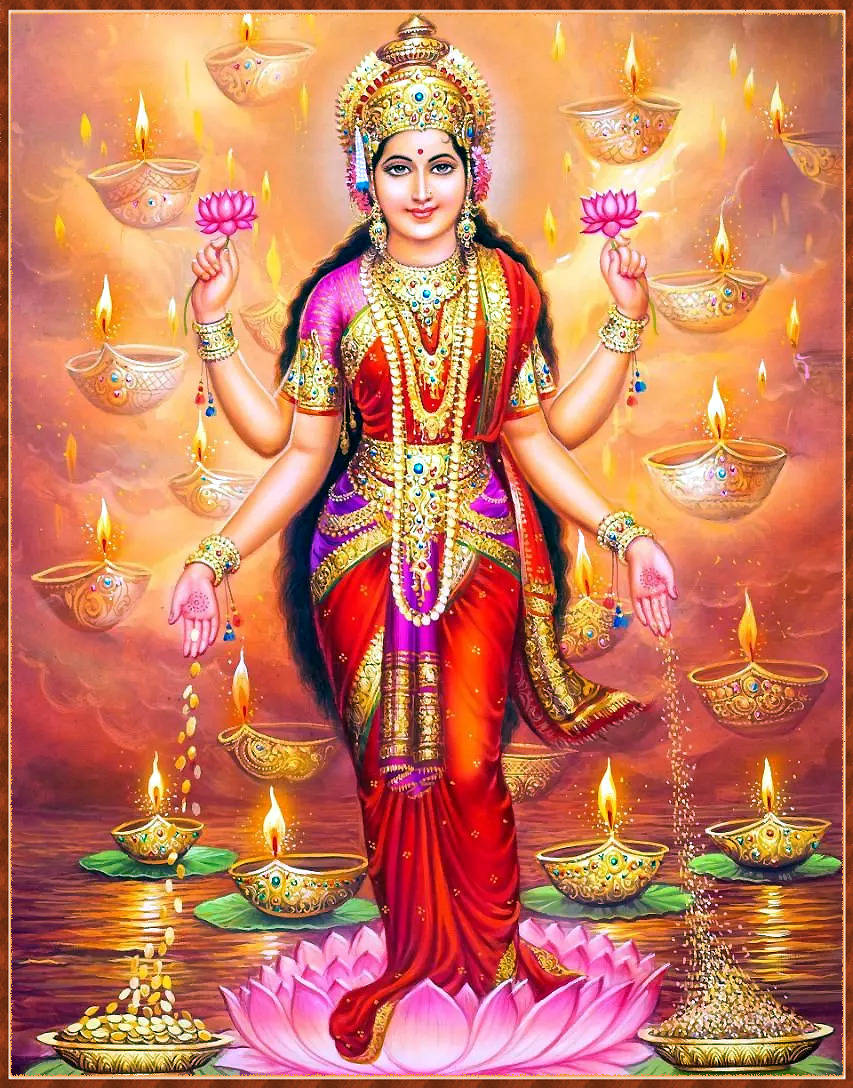 Download Standing Lakshmi Devi With Lamps Wallpaper | Wallpapers.com