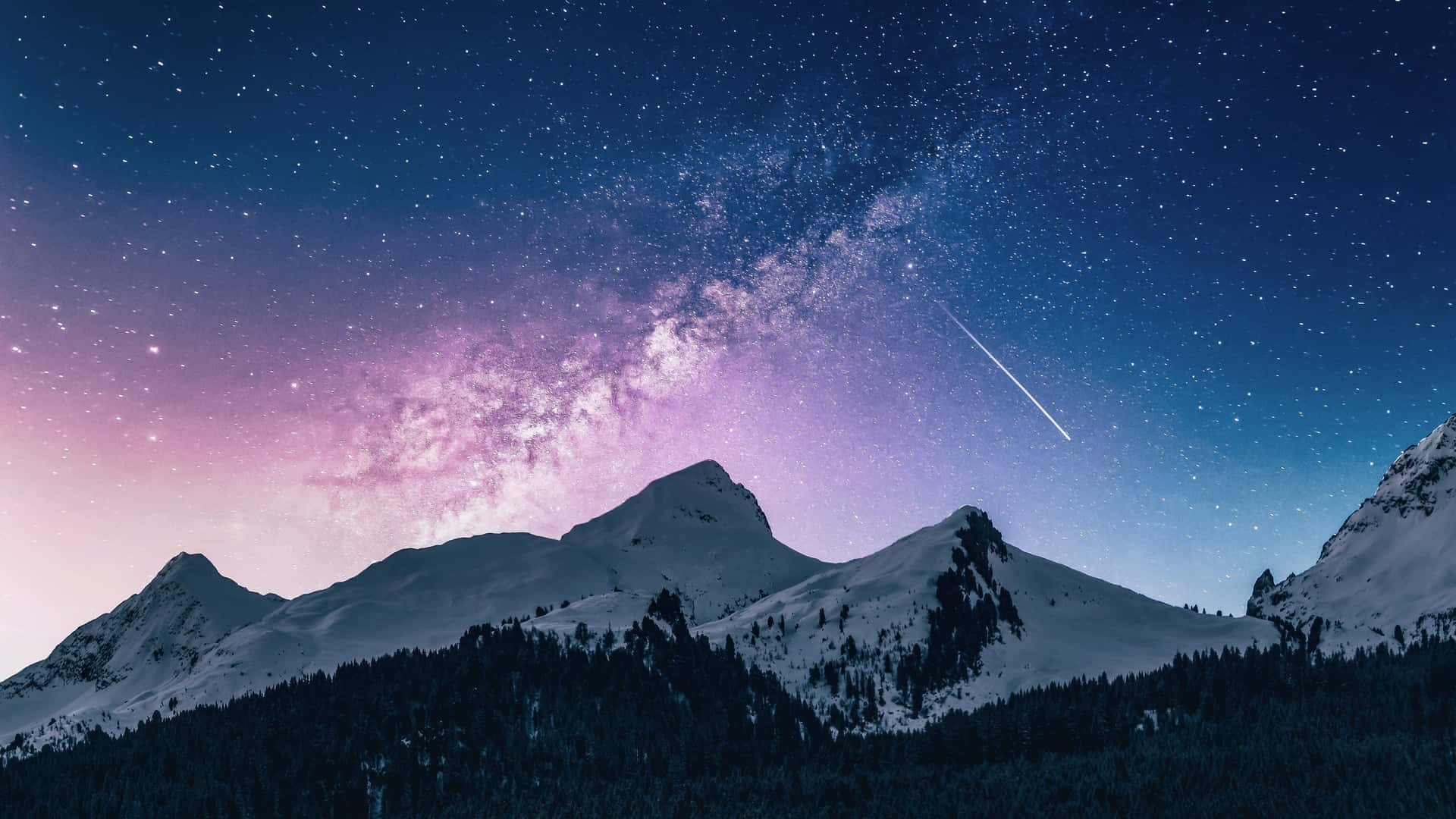 a mountain range with snow and a milky sky