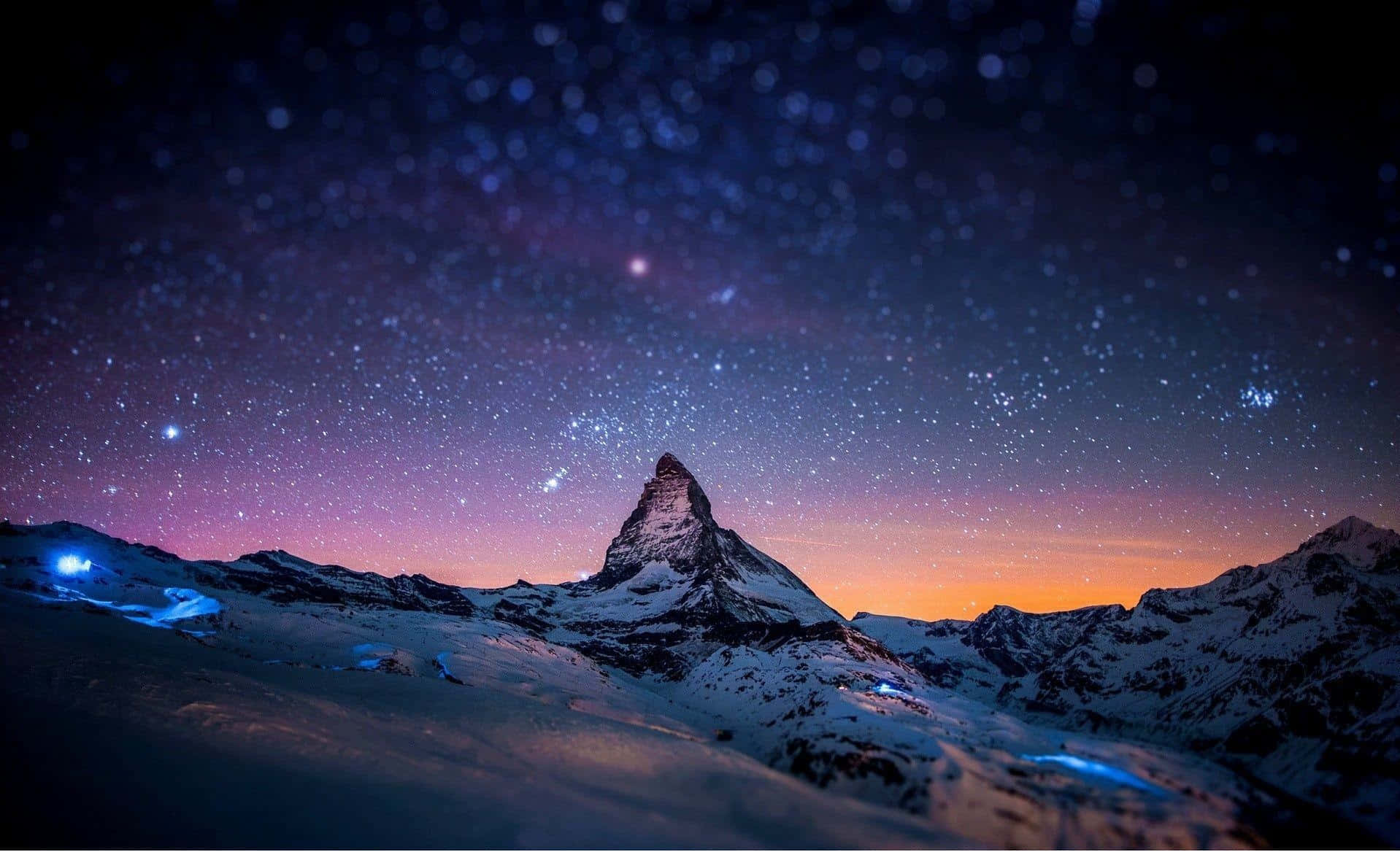 Starry_ Night_ Over_ Snowy_ Mountain_ Peak Wallpaper