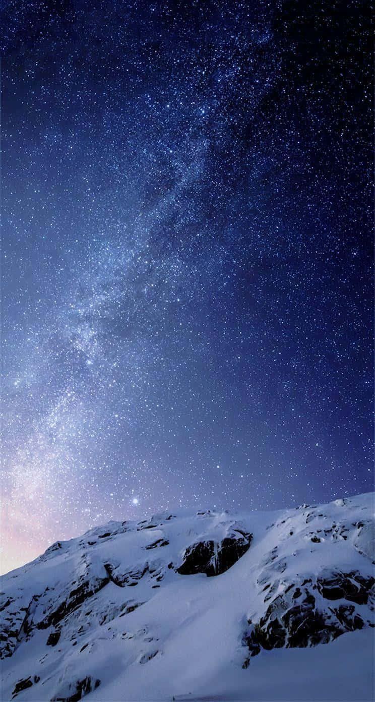 Starry_ Night_ Over_ Snowy_ Mountain_ Peak Wallpaper