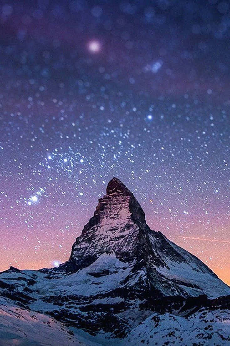 Starry_ Night_ Over_ Snowy_ Mountain_ Peak Wallpaper