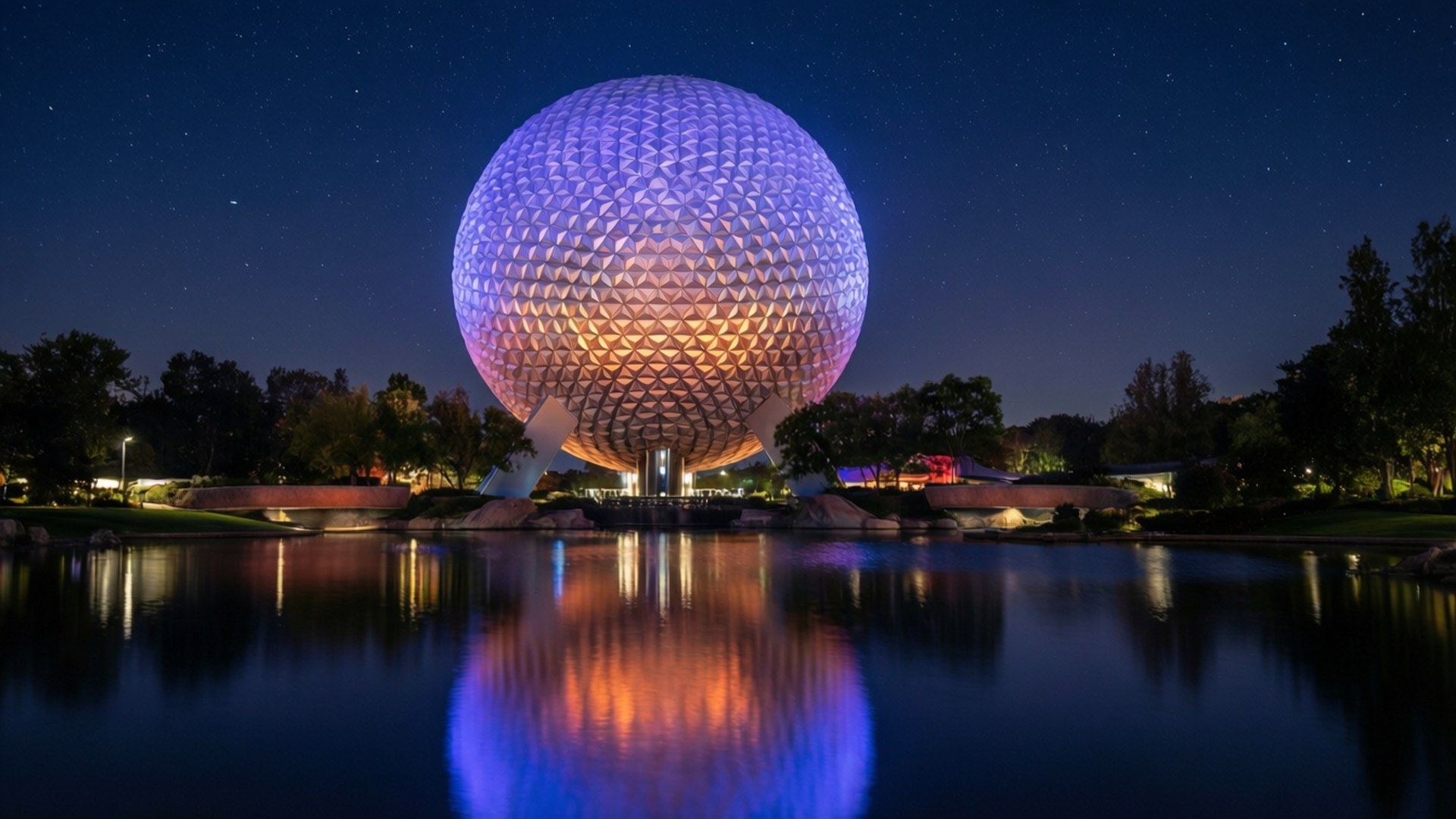 A mesmerizing nighttime view of the Epcot Ball with stars and reflections.