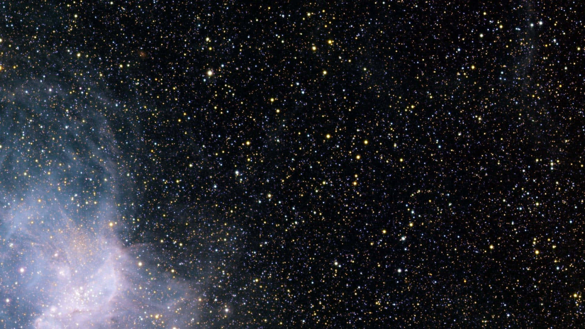 A Starry Sky With A Nebula Wallpaper