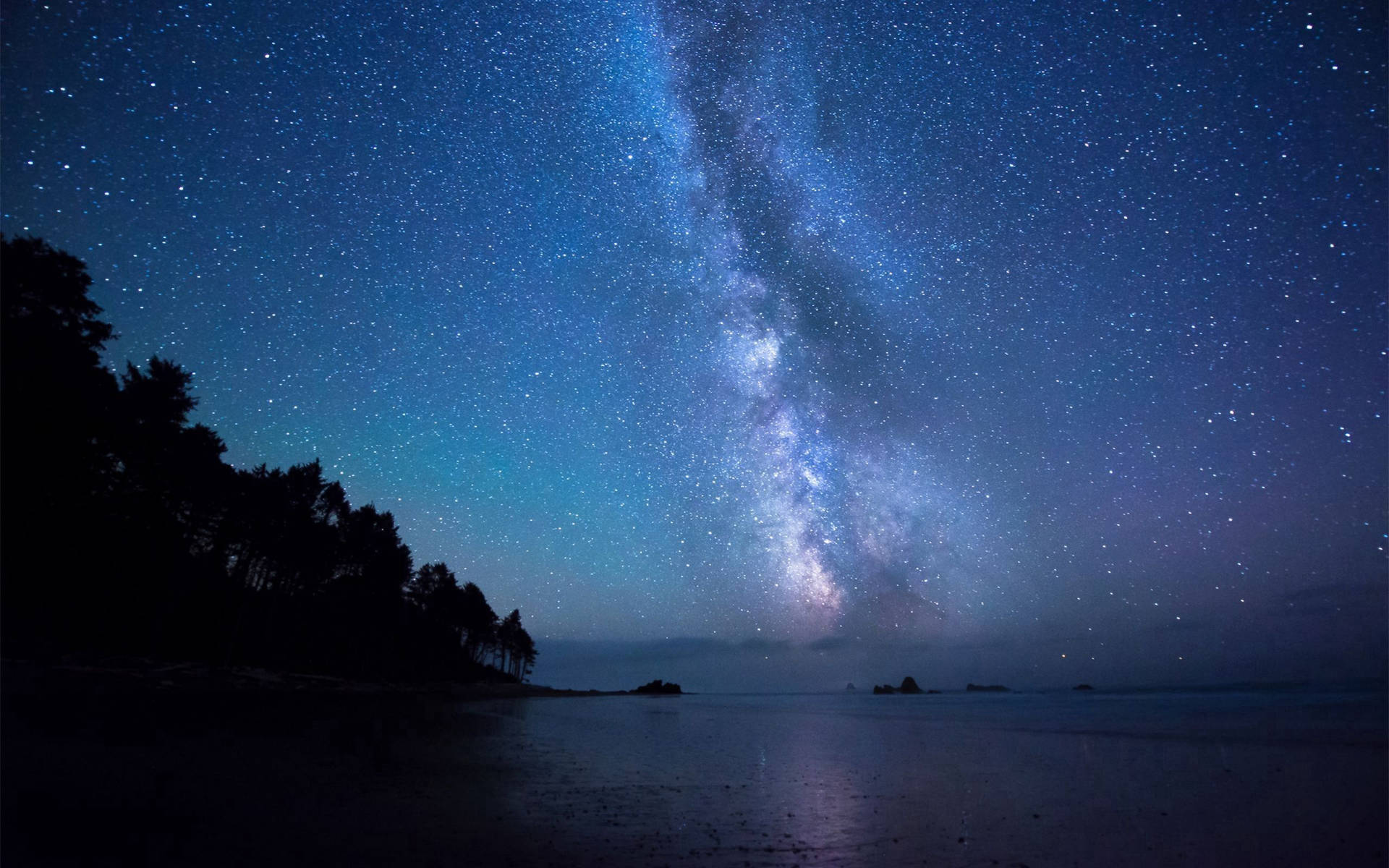 A beautiful shoreside view of the starry night sky Wallpaper