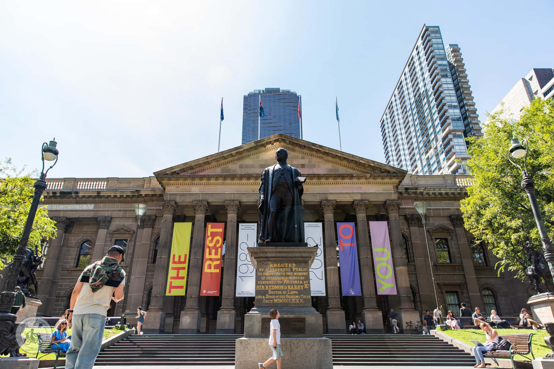 State Library Exteriorwith Statueand Banners Wallpaper