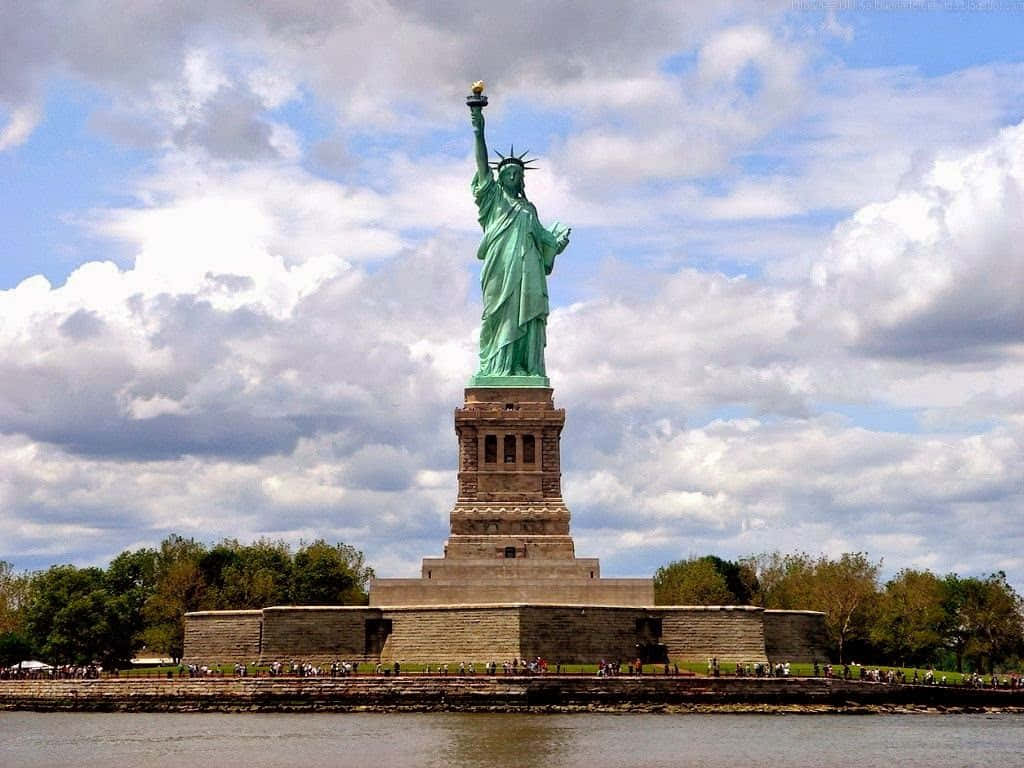 The Statue Of Liberty Is In The Middle Of The Water