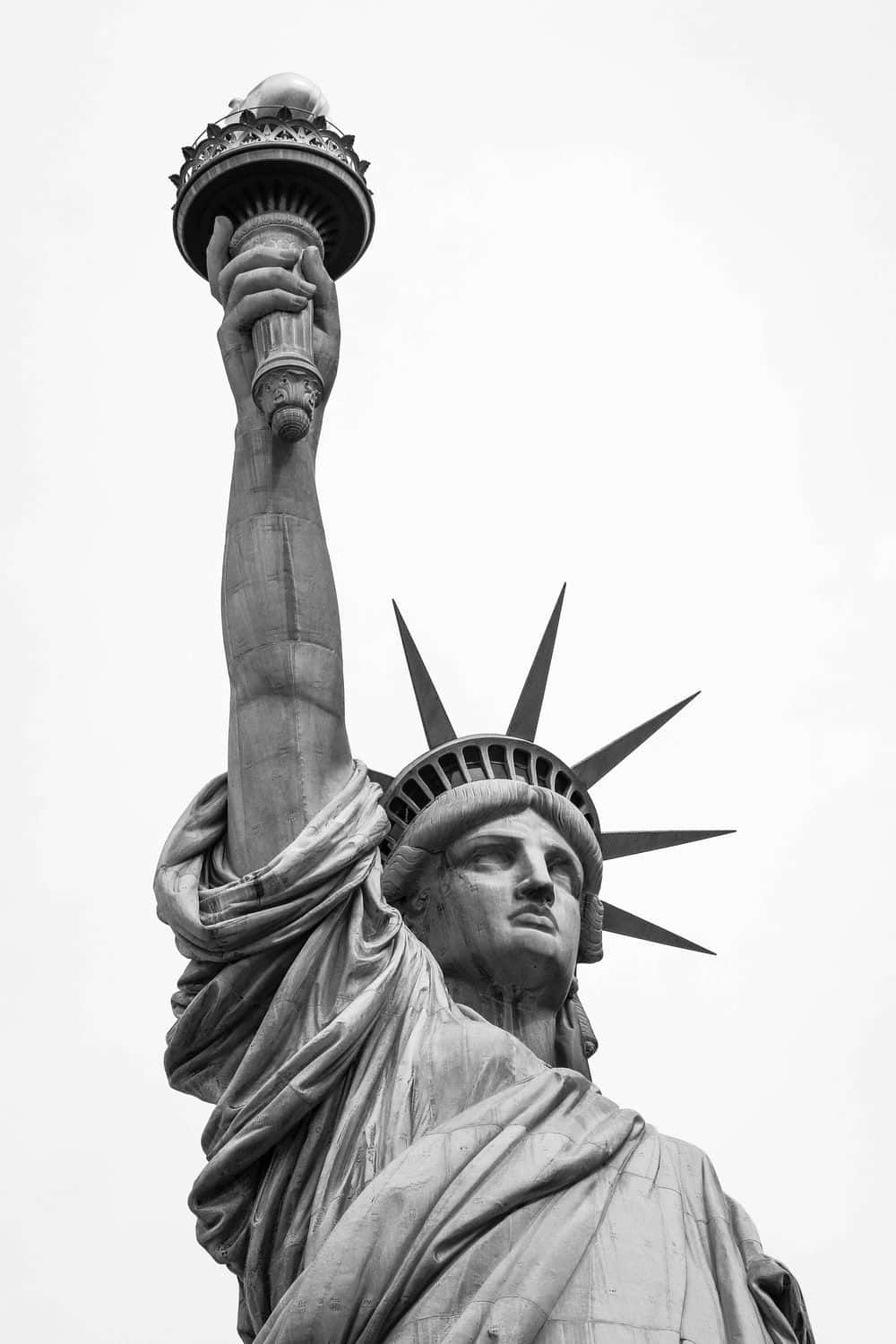An iconic symbol of freedom, the Statue of Liberty stands in the harbor of New York City, United States.