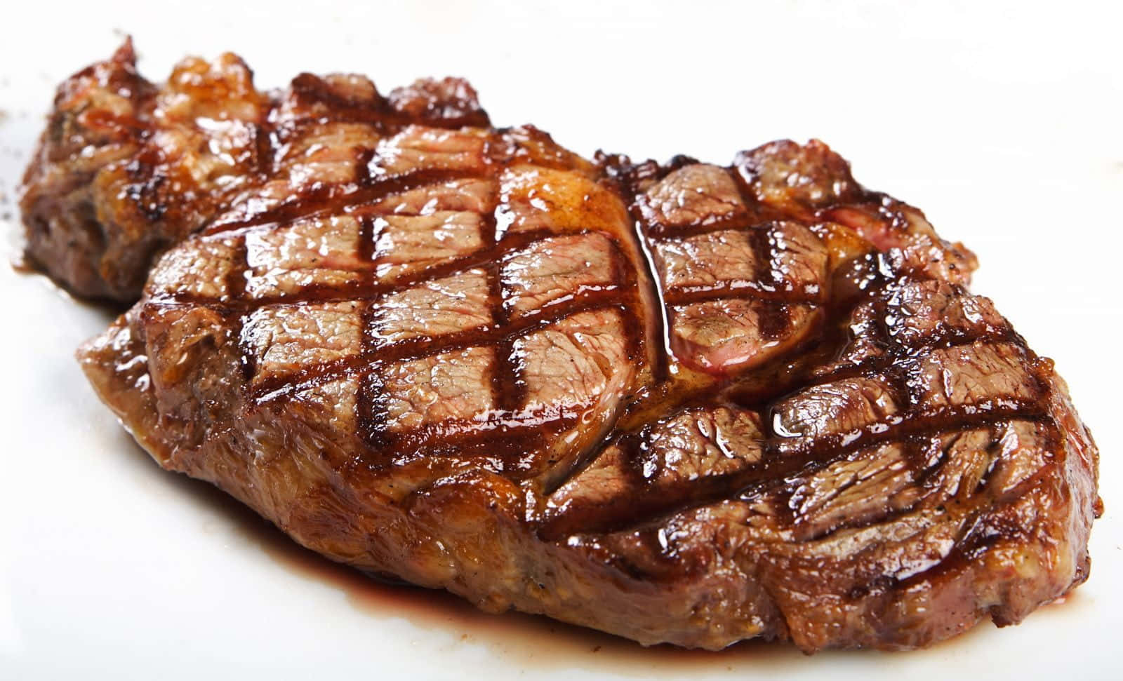 A Steak Is Sitting On A White Plate