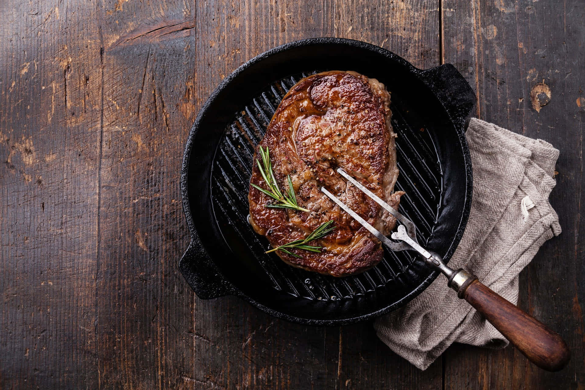 A Steak Is Being Cooked In A Cast Iron Skillet