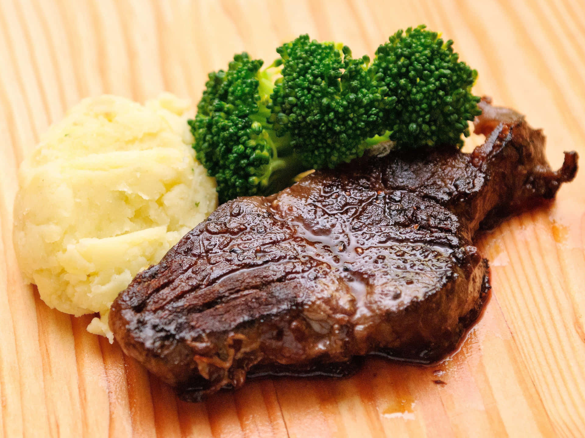 A Steak With Broccoli And Mashed Potatoes