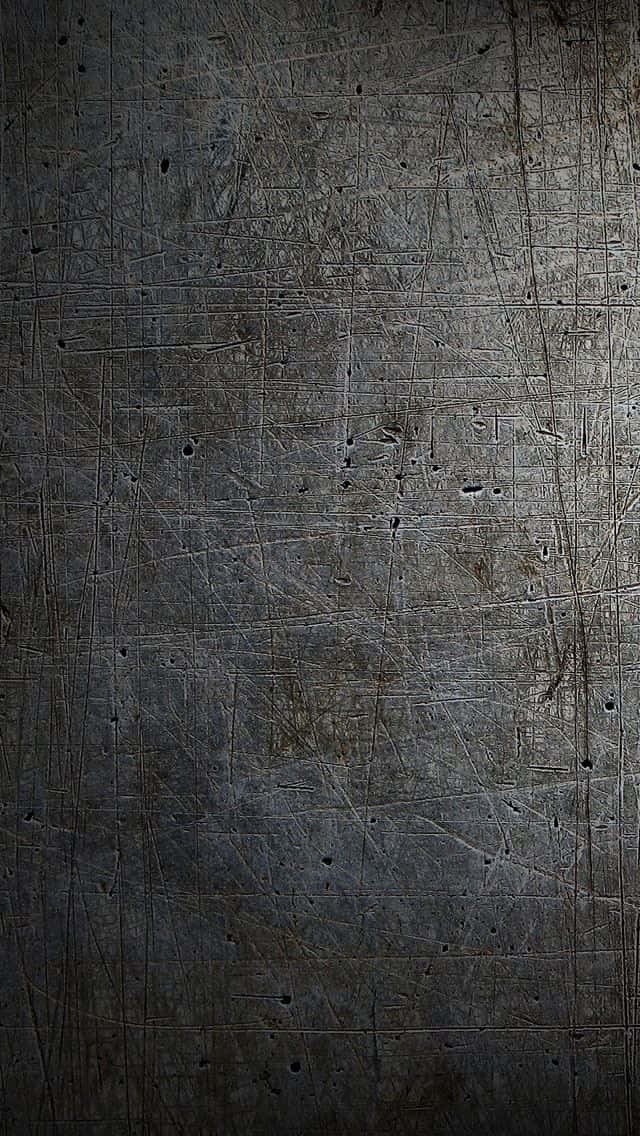 Et sort metal baggrund med et lys, der skinner på det Wallpaper