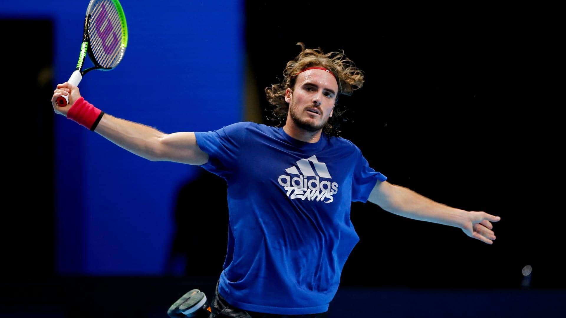 Stefanos Tsitsipas With Arms Stretched Wallpaper