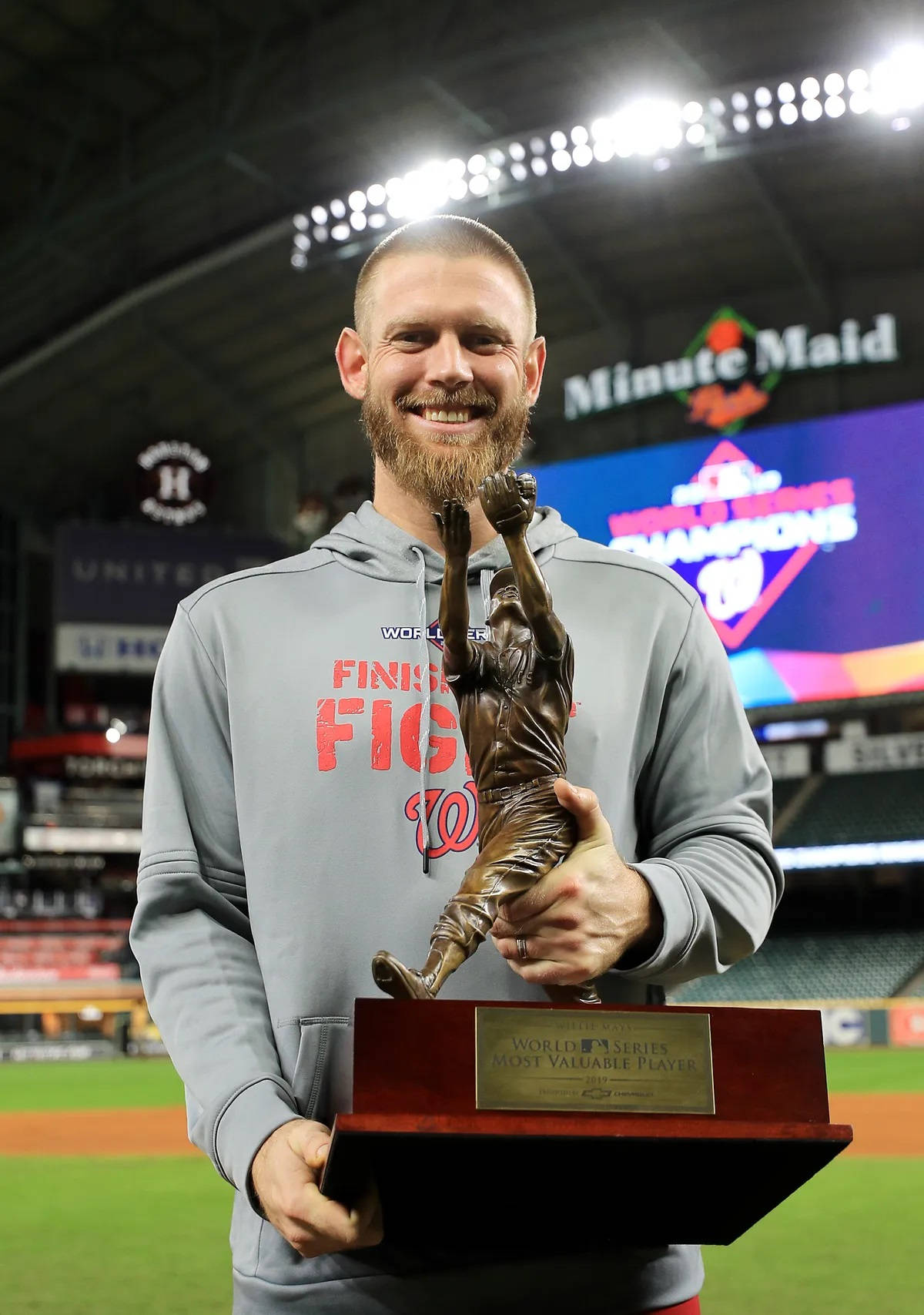 Stephen Strasburg Holding His Mvp Trophy Smiling Wallpaper