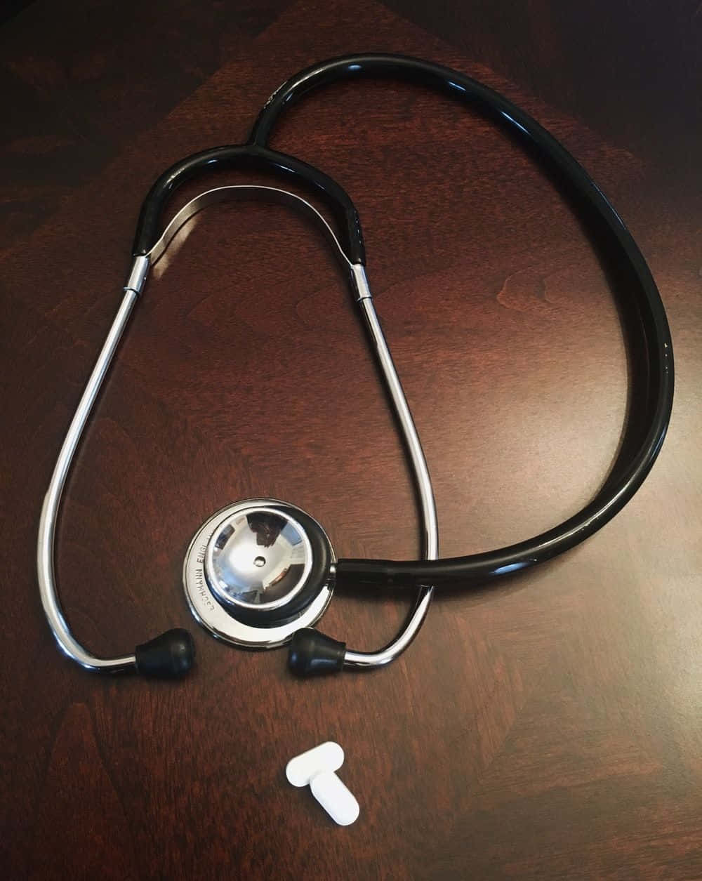 A stethoscope on a wooden surface