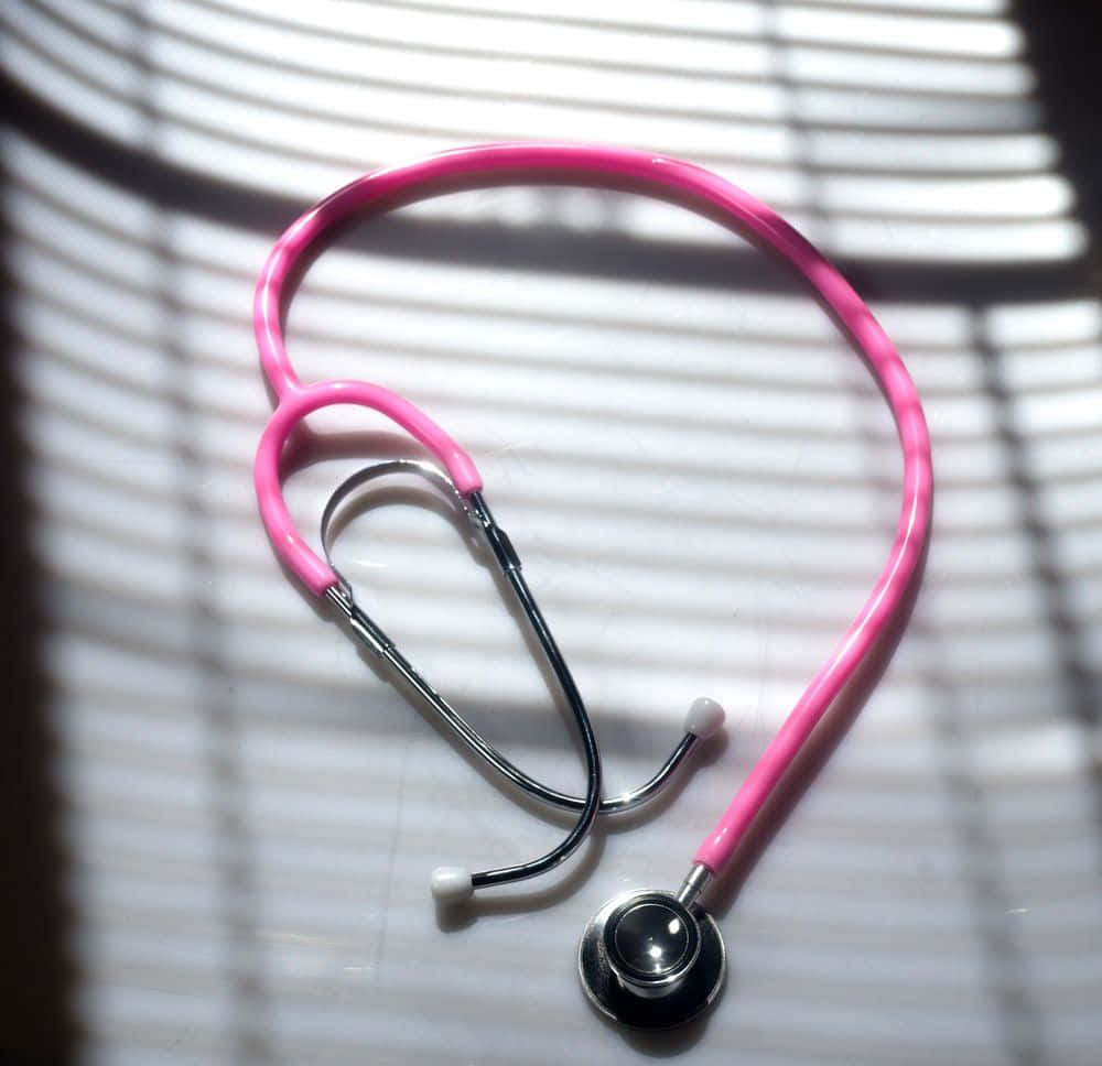 A doctor's stethoscope on a wooden surface