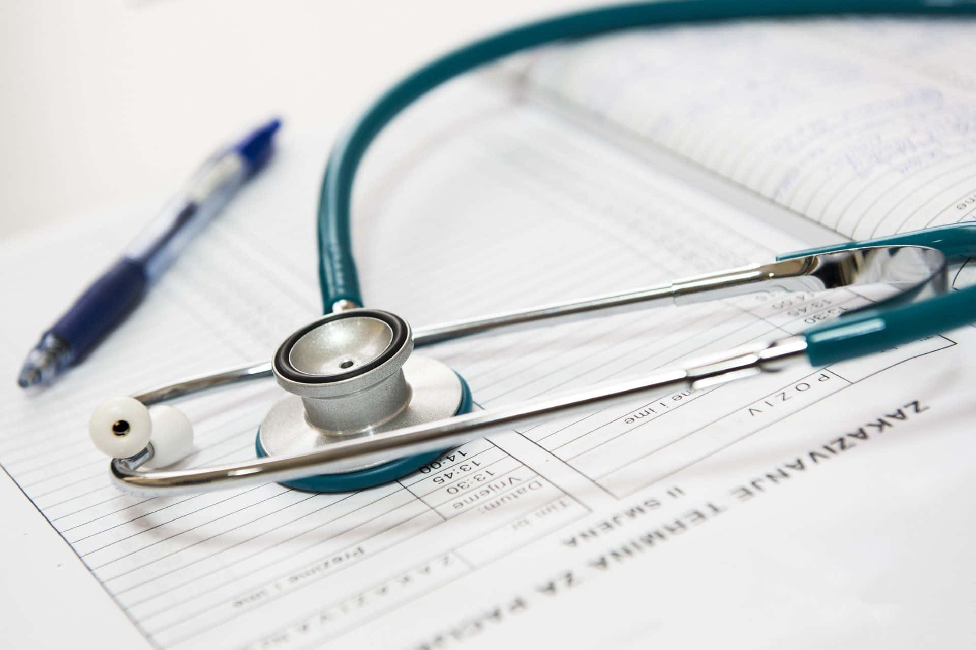 Close-up image of a stethoscope resting on a wooden surface.