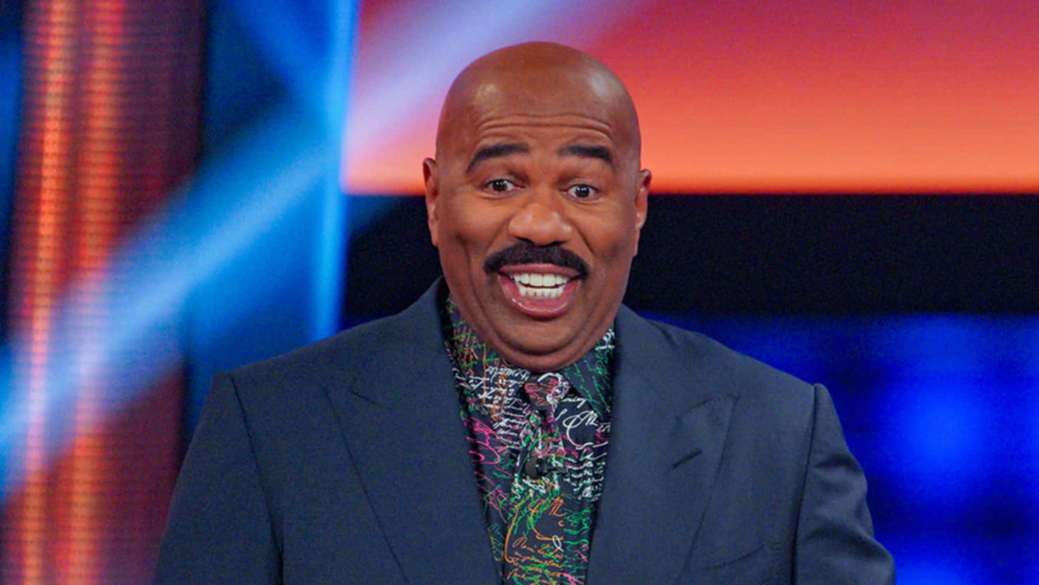 Steve Harvey Smiling In A Colorful Shirt Picture