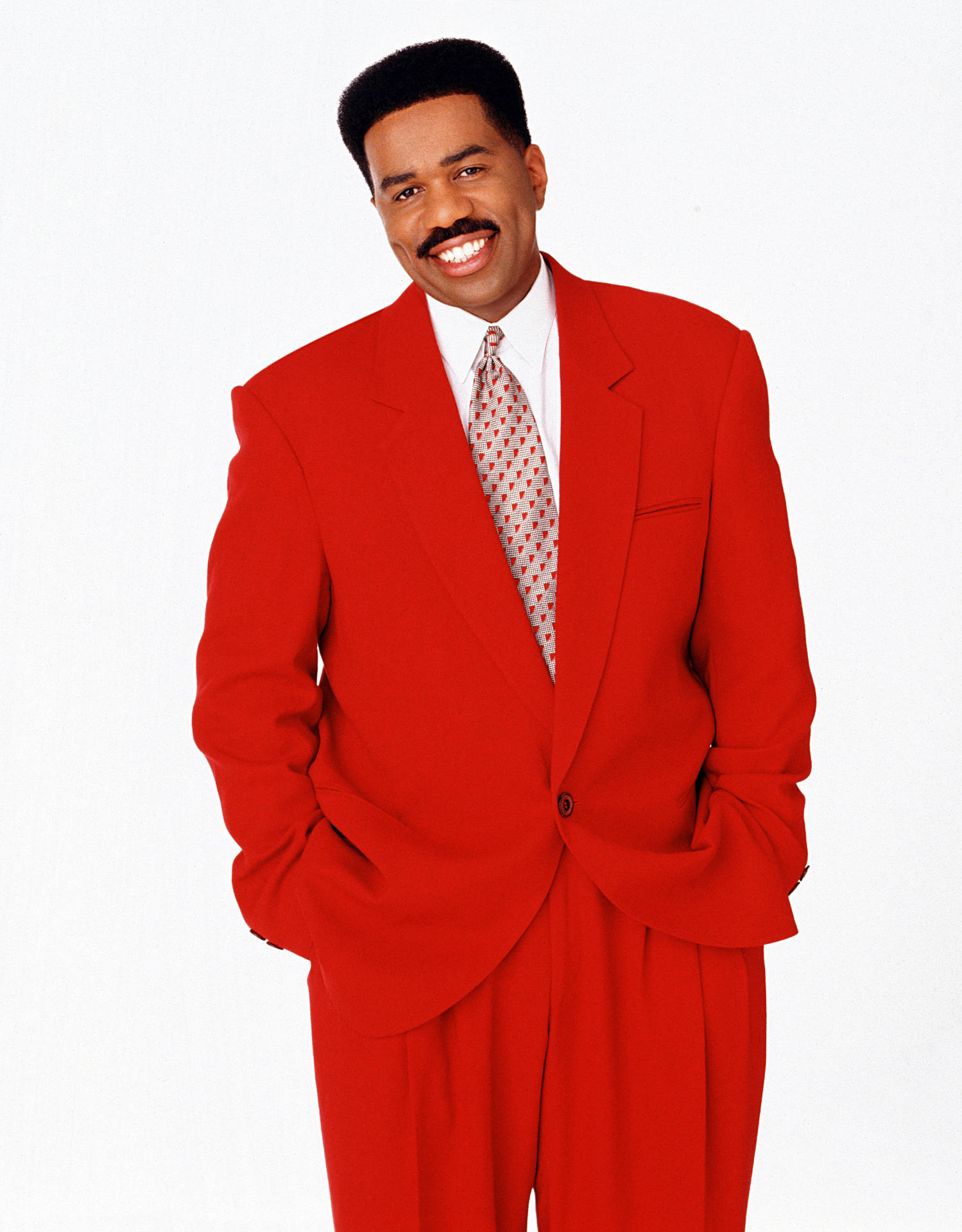 Steve Harvey Smiling In A Red Suit Wallpaper