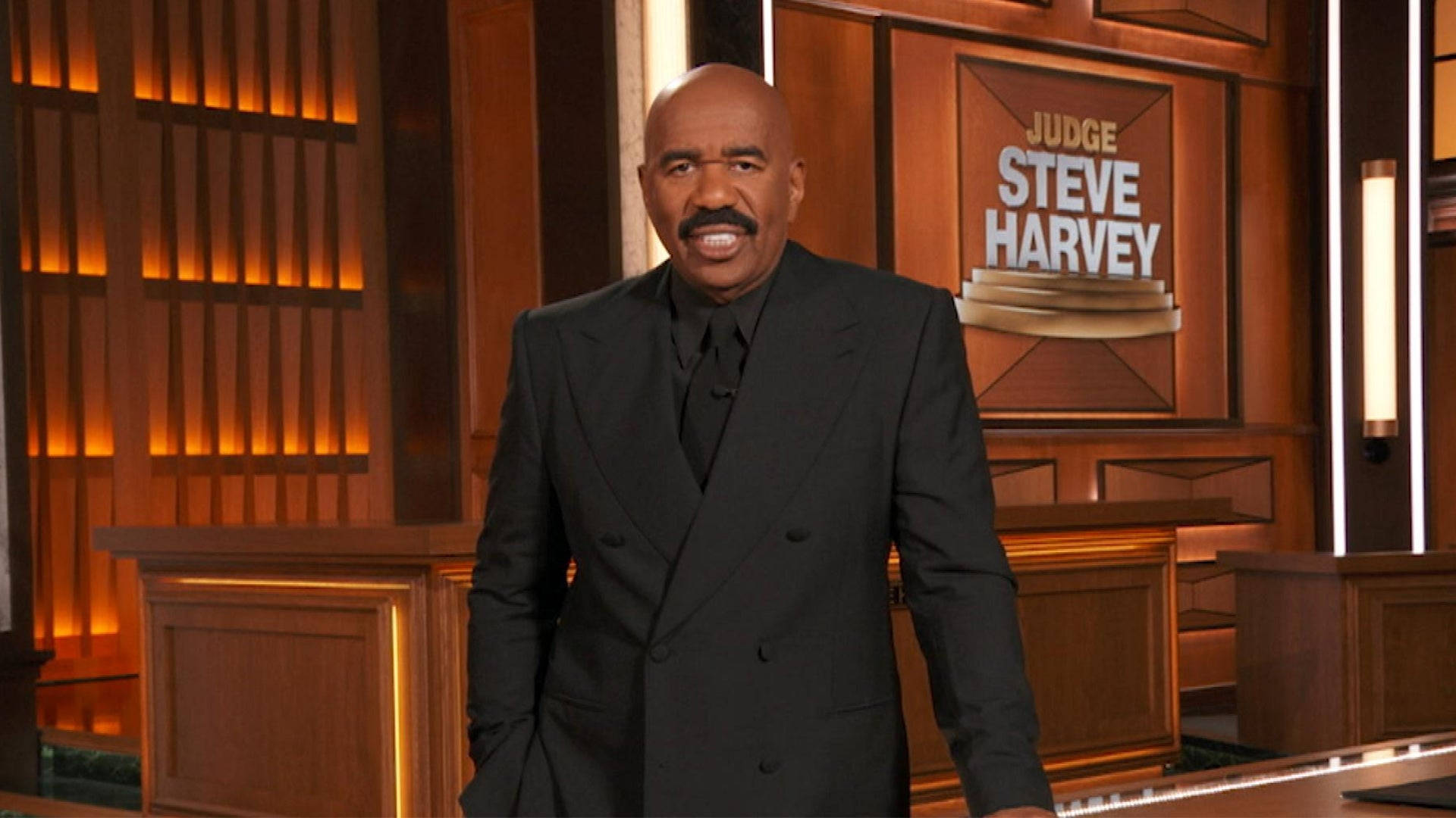 Steve Harvey With A Brown Backdrop Background