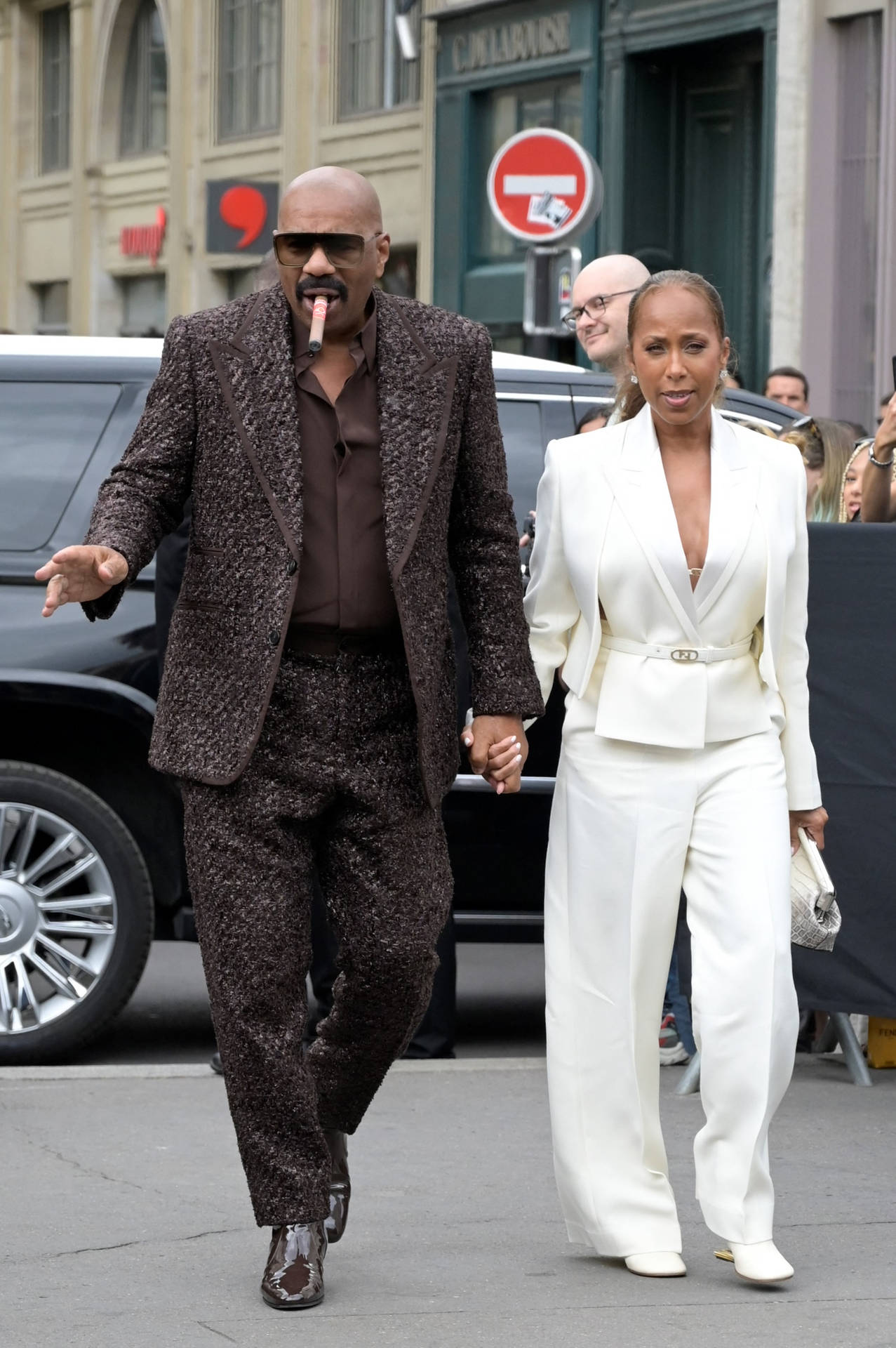 Steve Harvey With A Cigar And His Wife Background
