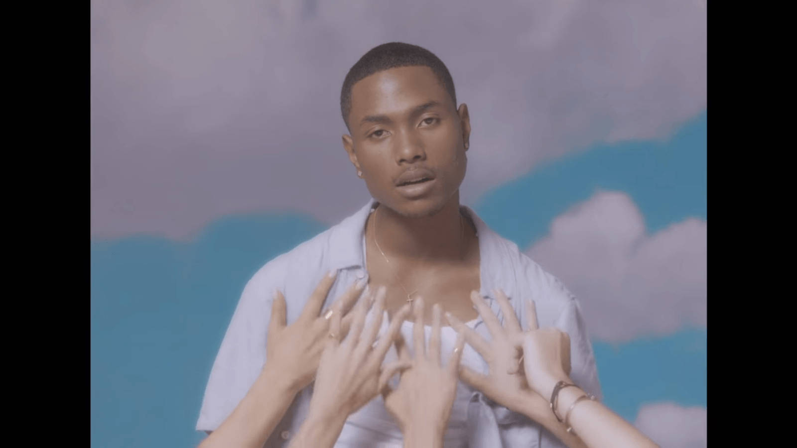 Steve Lacy With Hands Reaching For His Chest