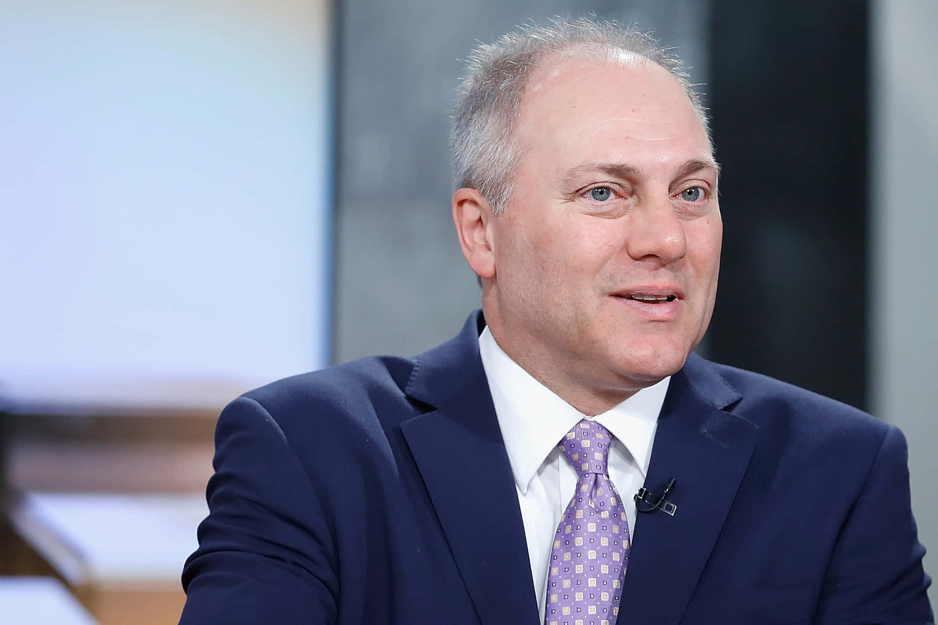 Steve Scalise confidently smirking during an interview Wallpaper