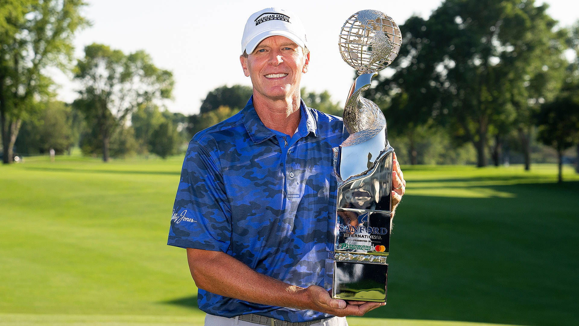 Champion Golfer Steve Stricker Holding Trophy Triumphantly Wallpaper