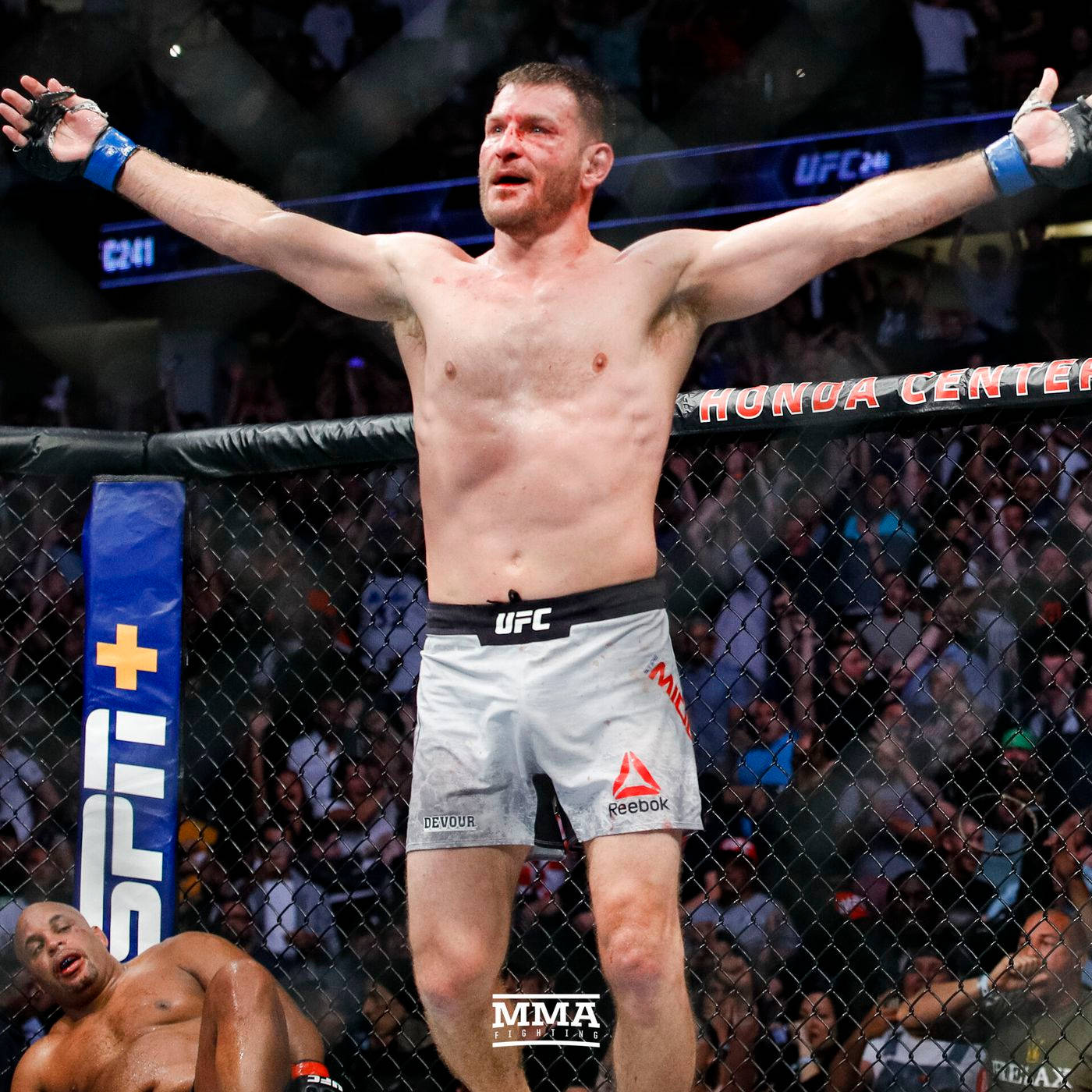 Stipe Miocic With Defeated Opponent Wallpaper