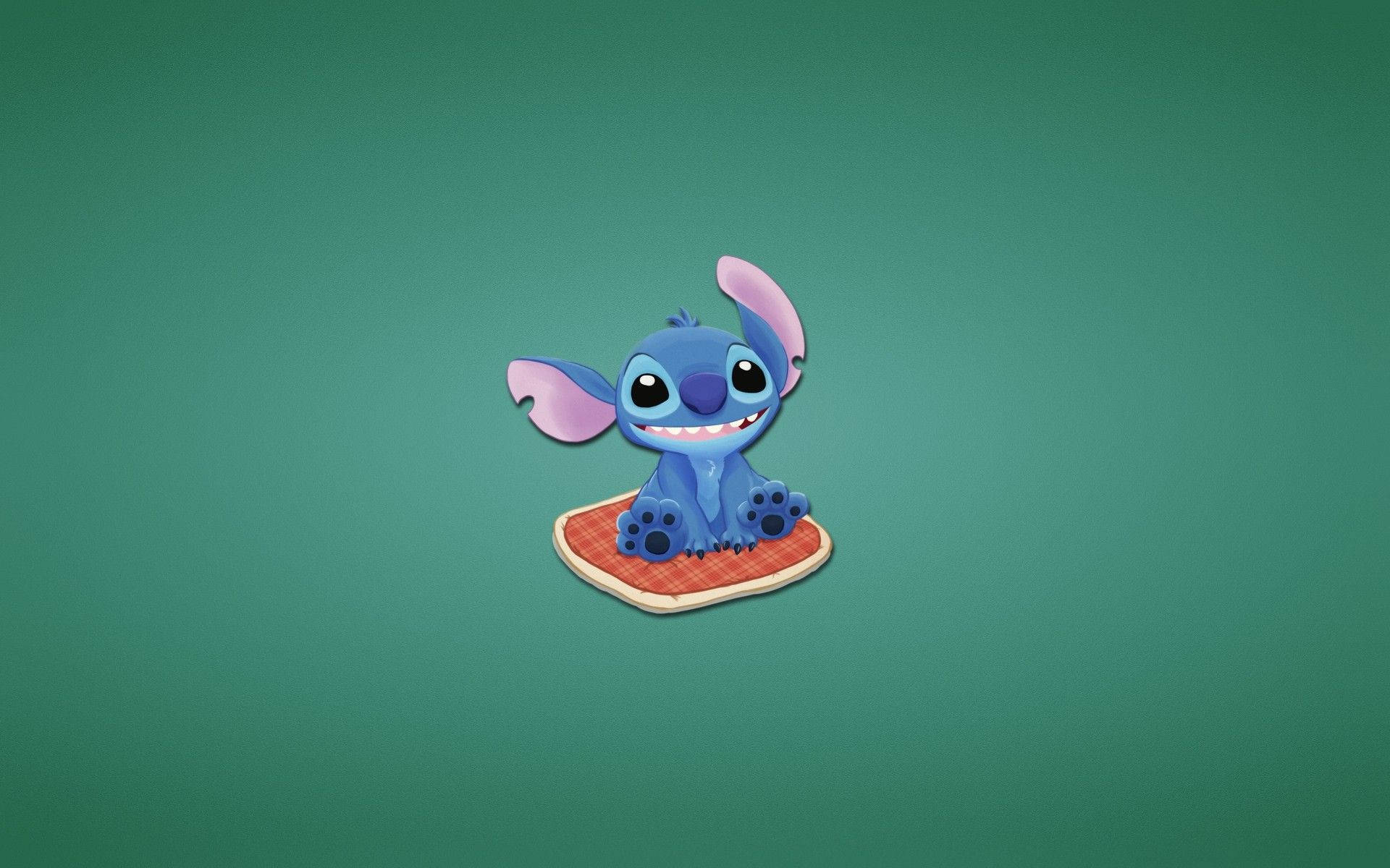 Stitch sitting on a red pillow wallpaper.