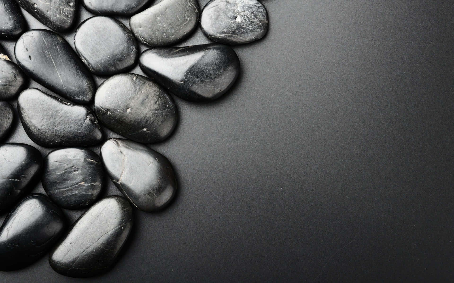 Black Pebbles On A Black Background