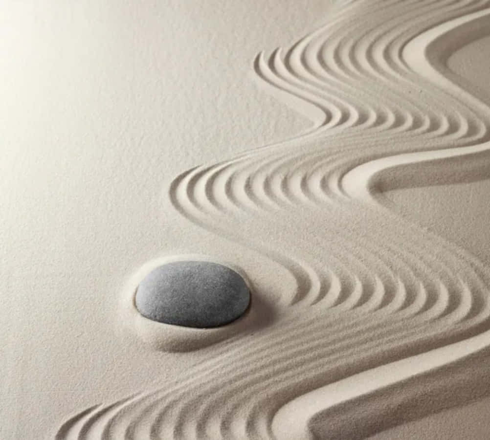 A Zen Garden With A Stone In The Sand