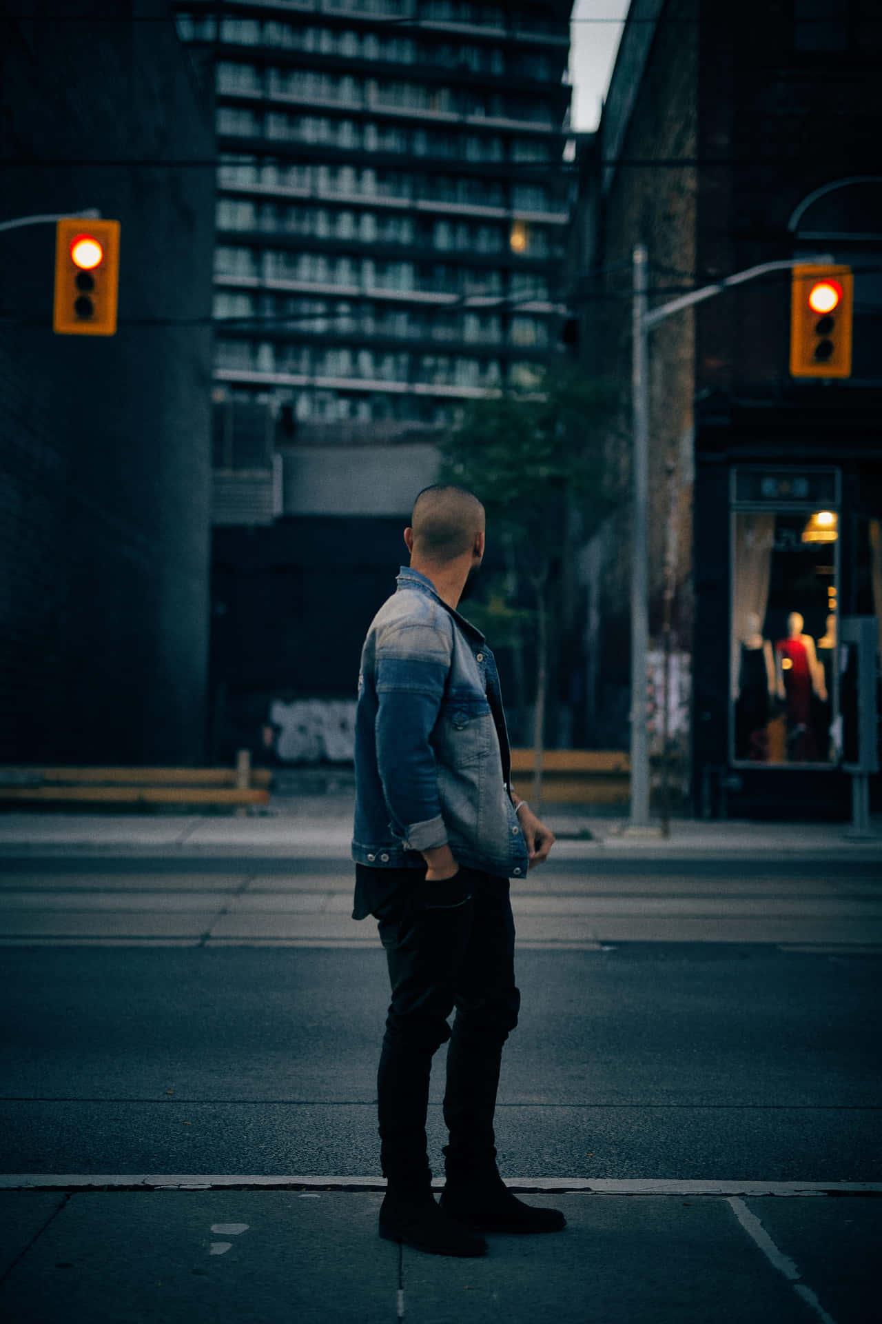 A Man Standing On A Street Corner