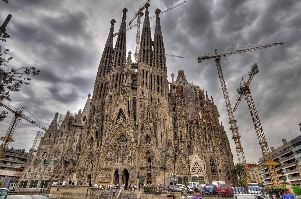 Skyerne raser grå Sagrada Familia som baggrund Wallpaper