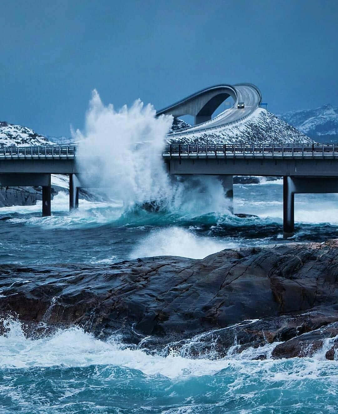 The Majestic Storseisundet Bridge Battling Powerful Ocean Waves Wallpaper