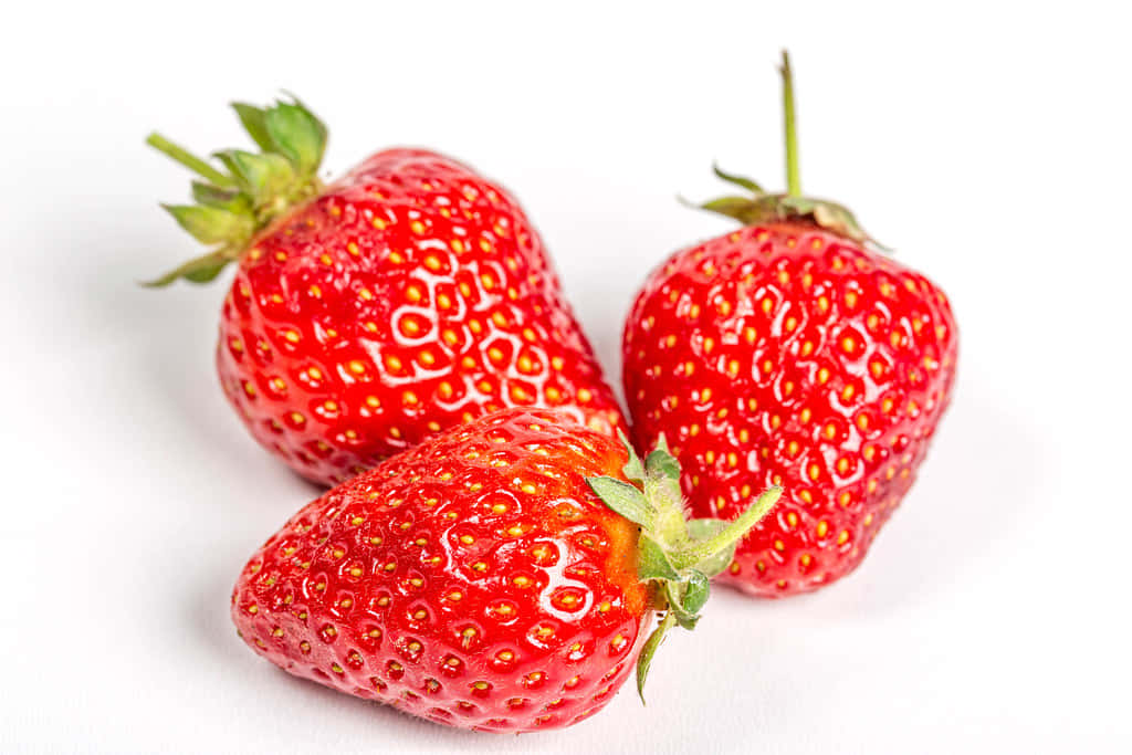 Three Ripe And Red Strawberries Background