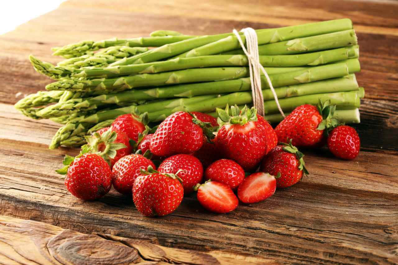Fresh Asparagus And Strawberries Background
