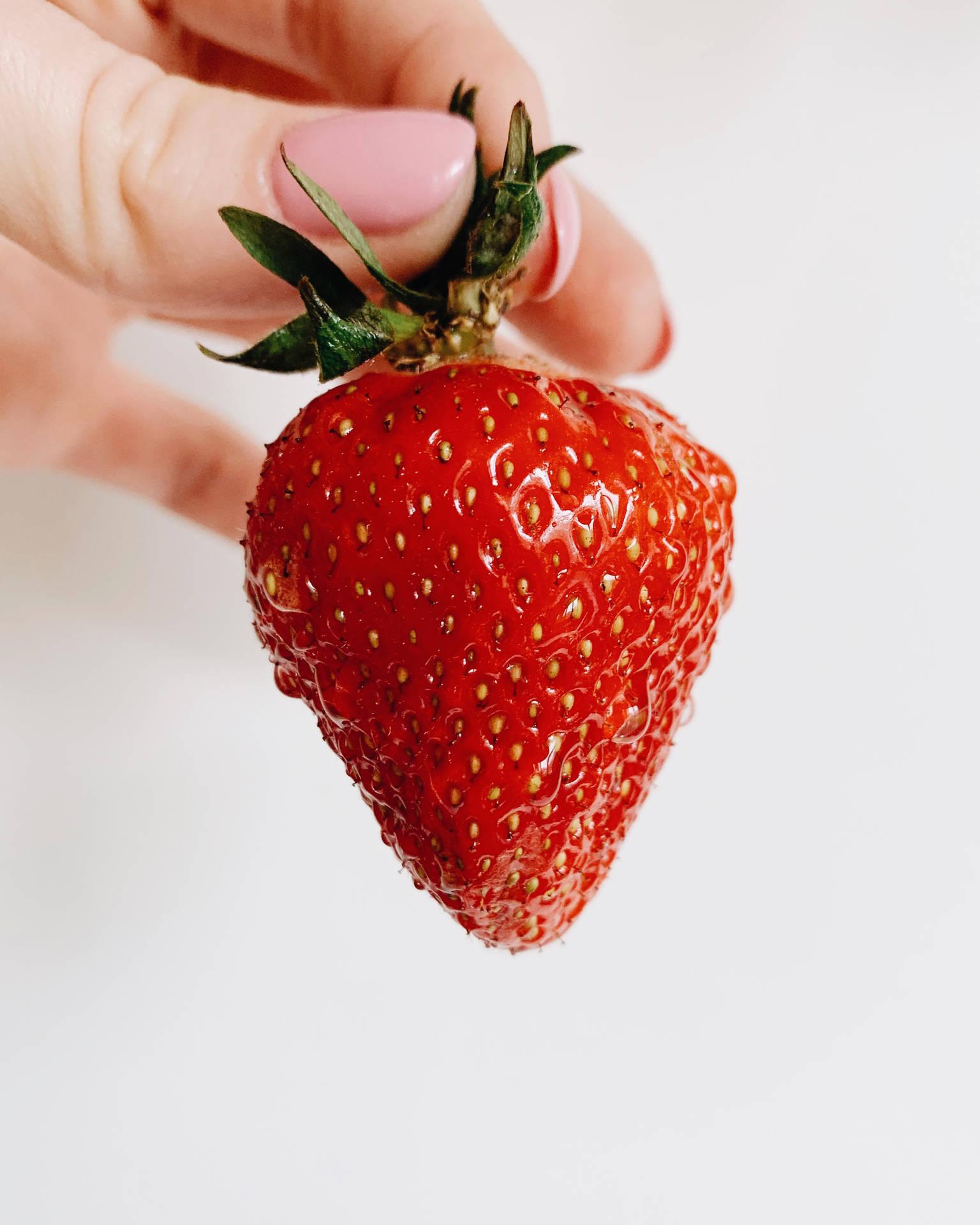 Strawberry Fruit Held By Hand