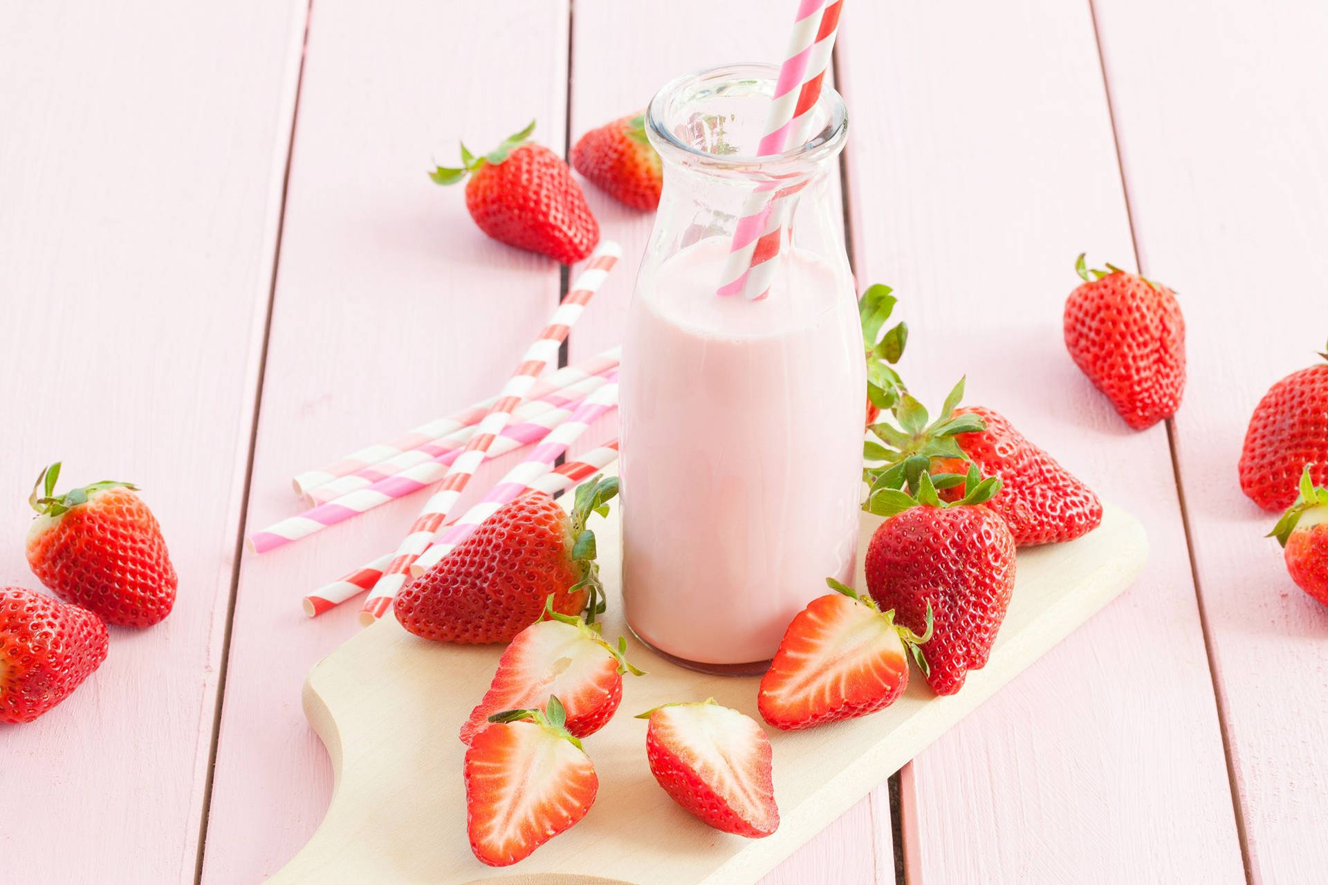 A Bottle Of Milk With Strawberries On A Pink Wooden Table Wallpaper
