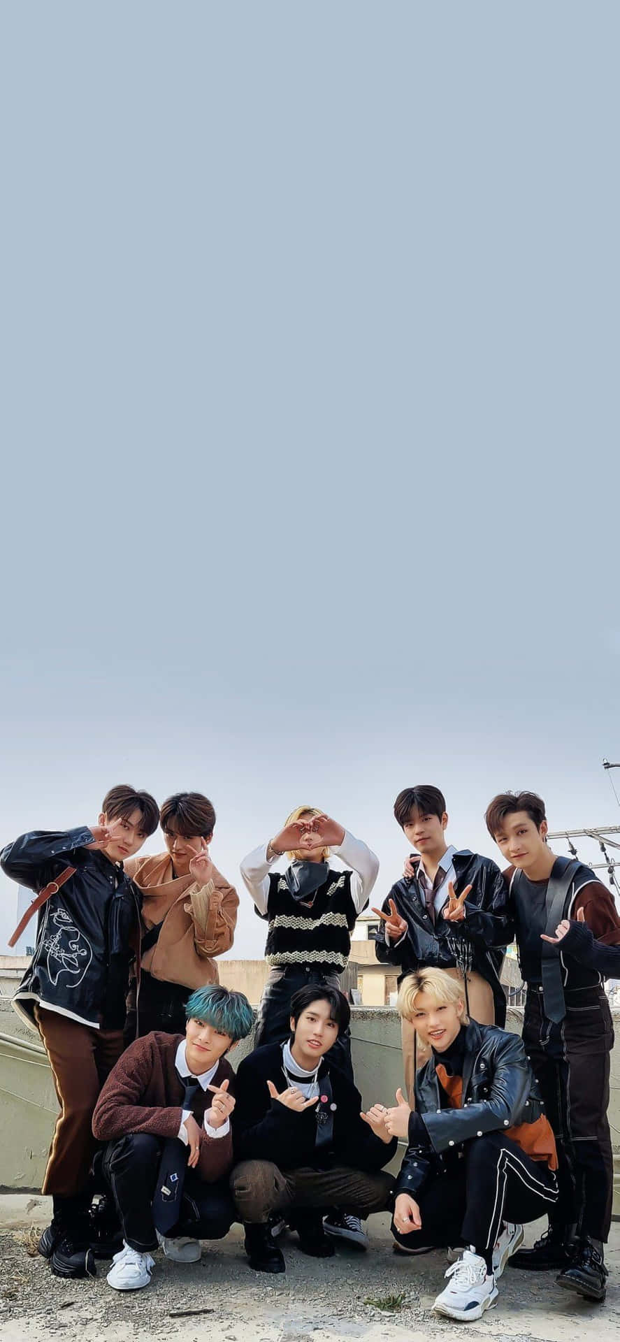 Members of South Korean pop group Stray Kids strike a pose in tech-inspired outfits for their 2020 promotional photo shoot. Wallpaper