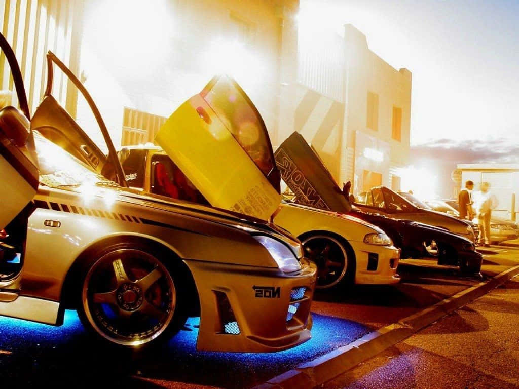 Et gruppe af biler parkeret i en parkeringsplads Wallpaper
