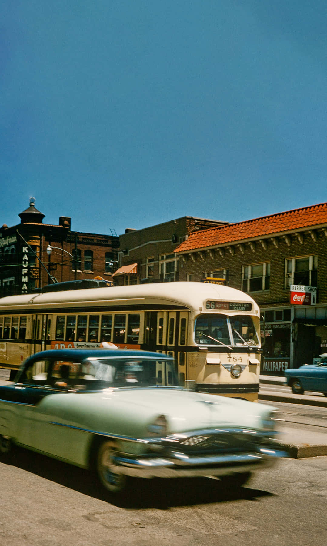 A Red Streetcar Train Passing Through Main Street in Kansas City Wallpaper