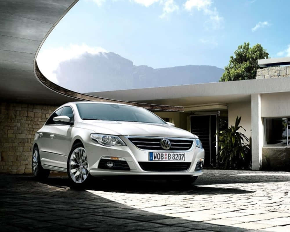 Striking Volkswagen Passat Cc In Motion Against Scenic Backdrop Wallpaper