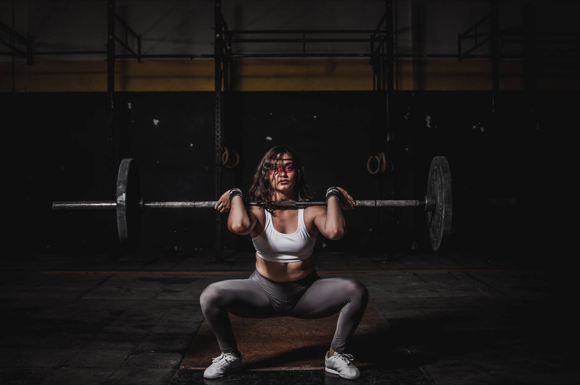 Determined Woman Mastering the Barbell Wallpaper