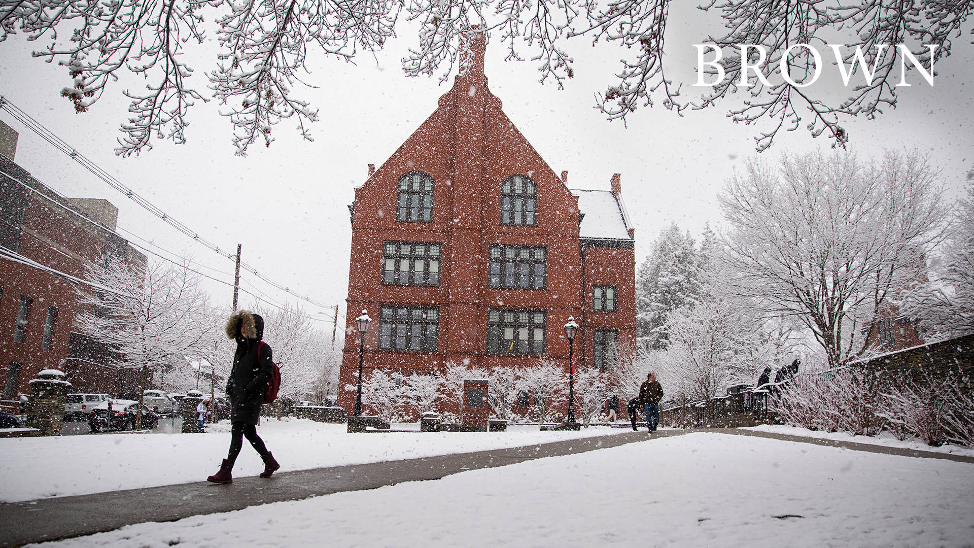 Student Walking At Brown University During Winter Wallpaper
