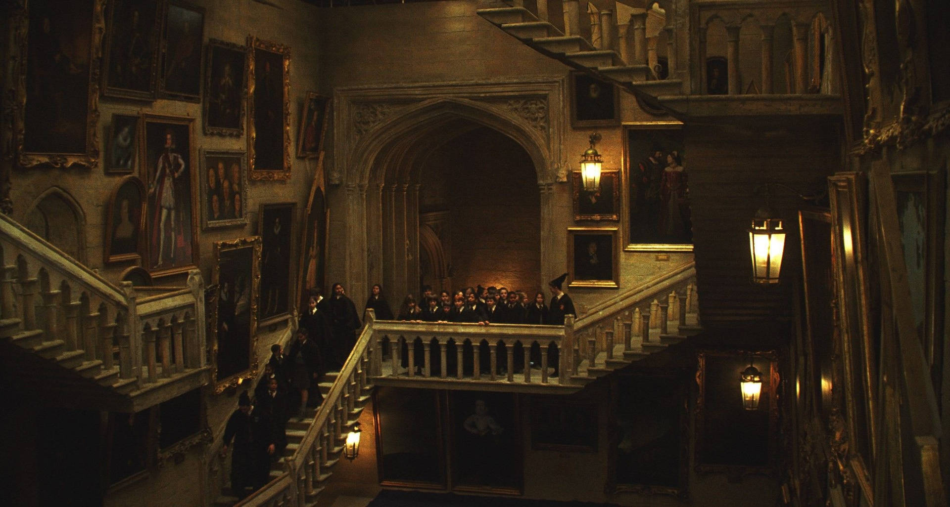 Students running up and down the staircase at Hogwarts Wallpaper