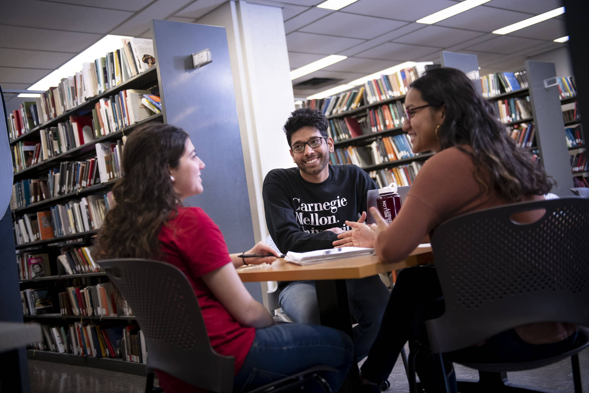 Students Talking At Carnegie Mellon University Library Wallpaper