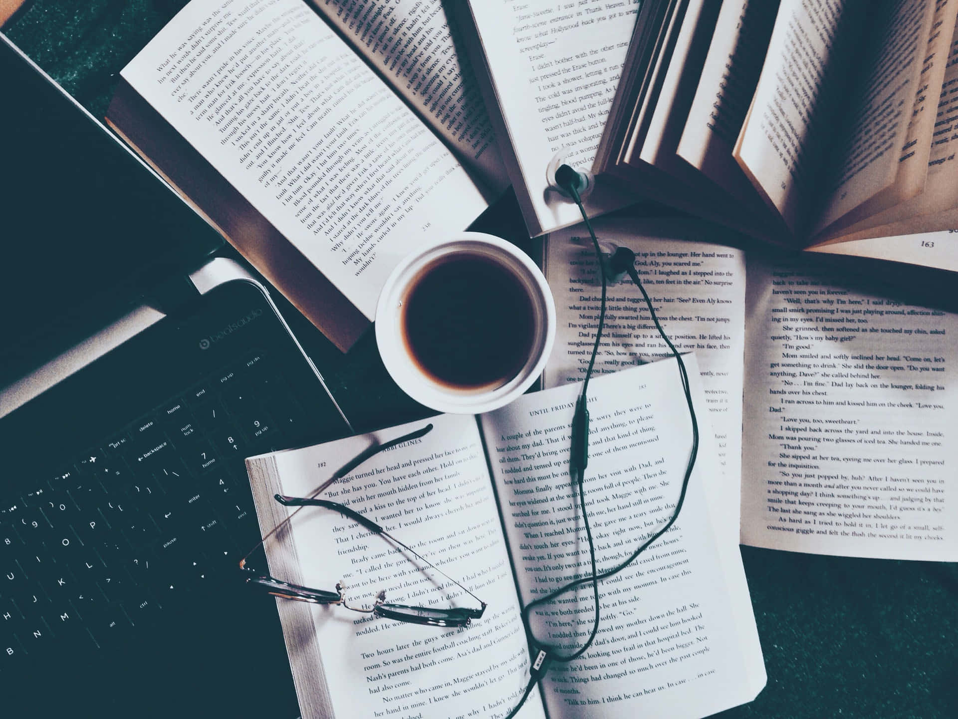 A Laptop, Books, And A Cup Of Coffee