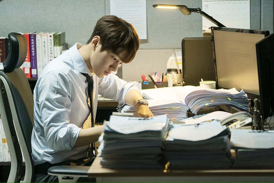 A Man Is Working At His Desk